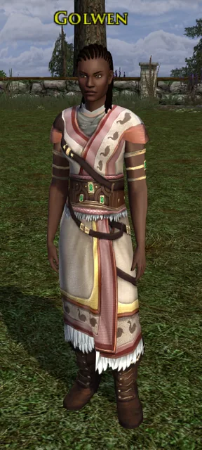 Golwen, a woman with braided hair in a cream and pink tunic with a wide belt